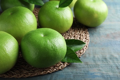Fresh ripe sweetie fruits on blue wooden table Photo of Fresh ripe sweetie fruits on blue wooden table