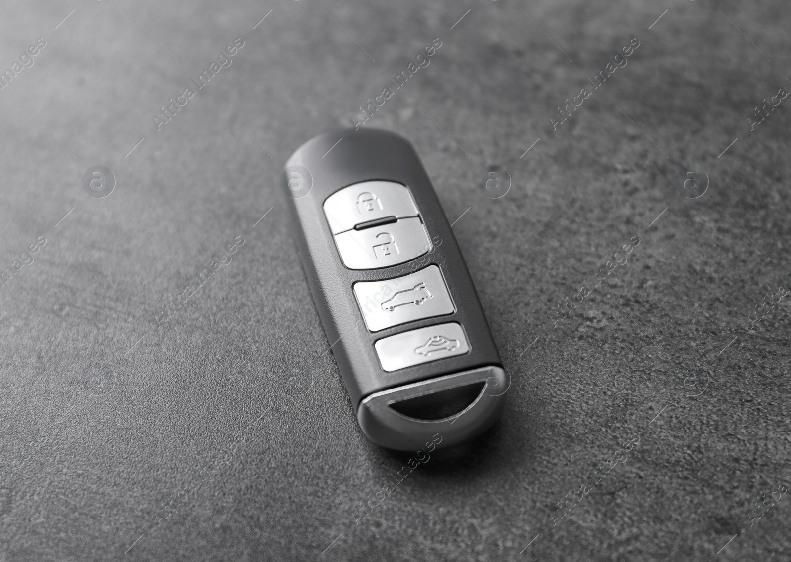 Modern car smart key on grey background Photo of Modern car smart key on grey background