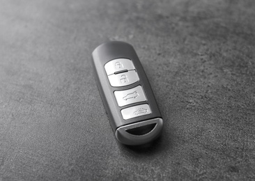 Modern car smart key on grey background Photo of Modern car smart key on grey background