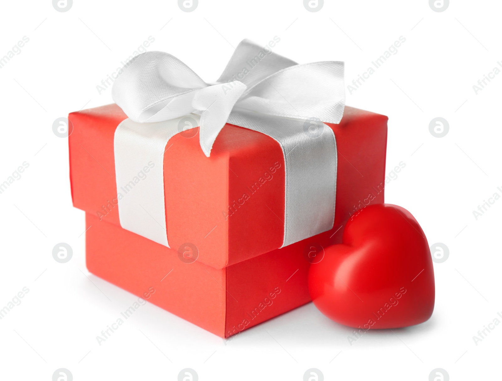 Beautiful gift box and red heart on white background. Valentine's day celebration Photo of Beautiful gift box and red heart on white background. Valentine's day celebration