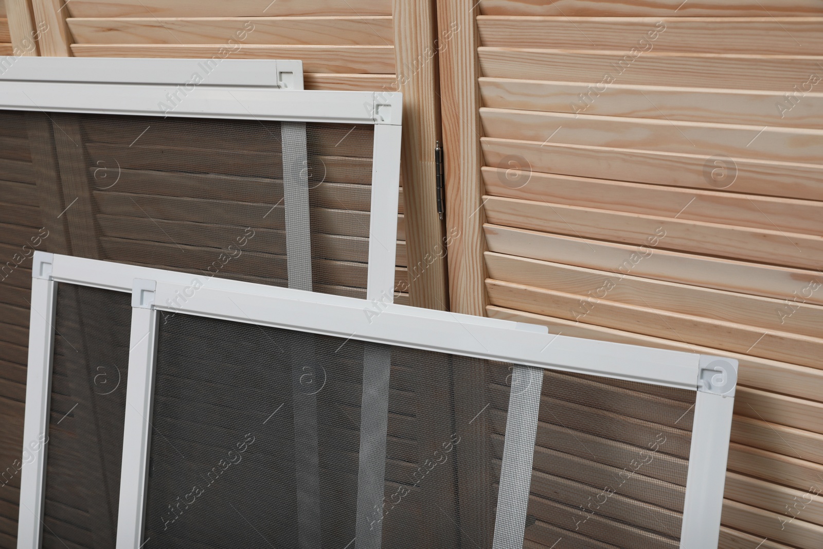 Set of window screens near wooden folding screen Photo of Set of window screens near wooden folding screen