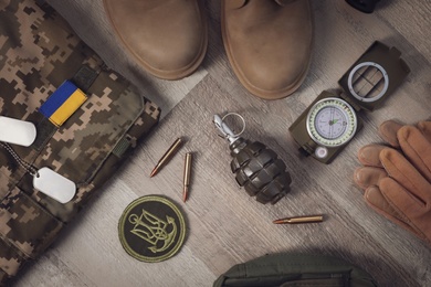 MYKOLAIV, UKRAINE - SEPTEMBER 19, 2020: Flat lay composition with Ukraine military outfit and equipment on floor Photo of MYKOLAIV, UKRAINE - SEPTEMBER 19, 2020: Flat lay composition with Ukraine military outfit and equipment on floor