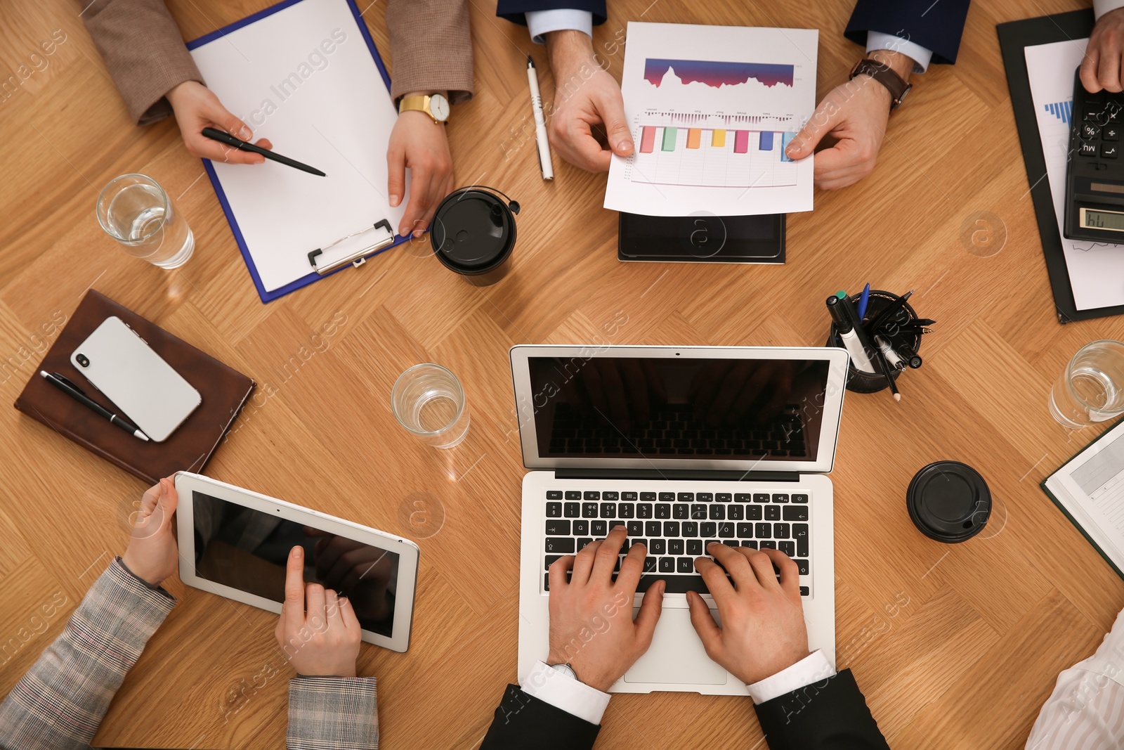 Businesspeople having meeting at table, top view. Management consulting Photo of Businesspeople having meeting at table, top view. Management consulting
