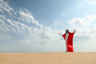 Jesus Christ raising hands in desert. Space for text Photo of Jesus Christ raising hands in desert. Space for text