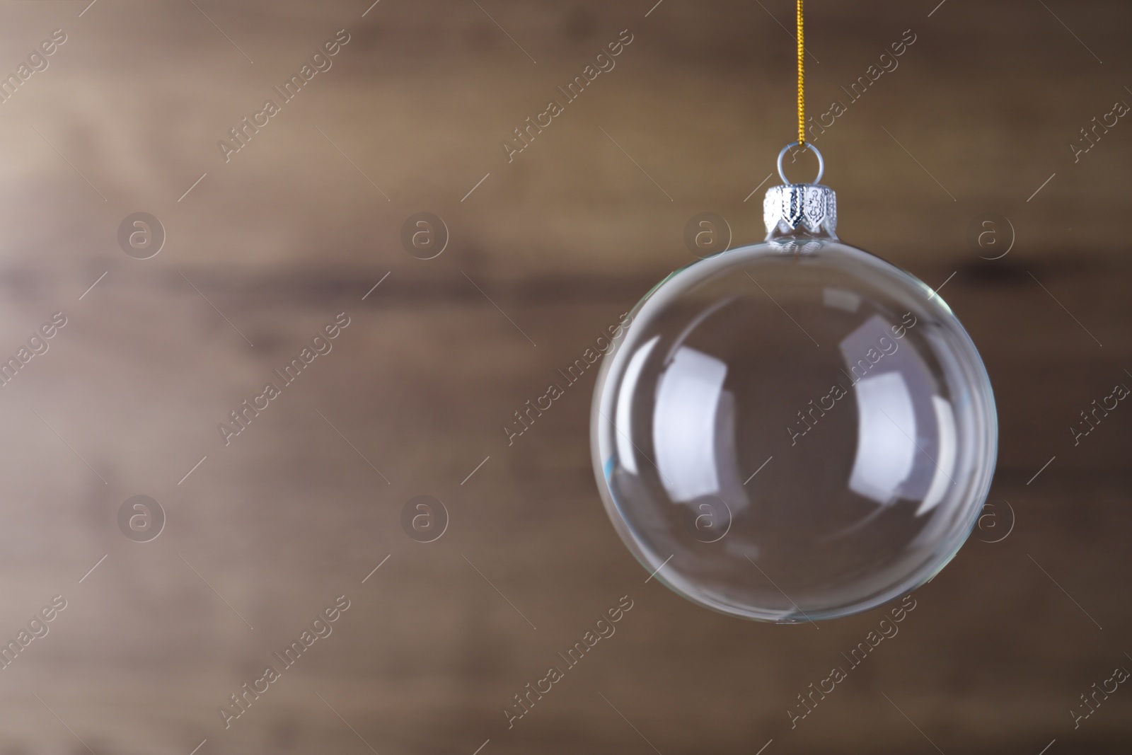 Transparent glass Christmas ball on blurred background. Space for text Photo of Transparent glass Christmas ball on blurred background. Space for text