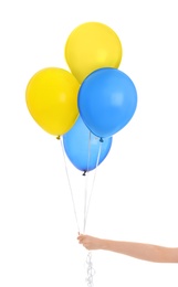 Woman holding many balloons in colors of Ukrainian flag on white background, closeup Image of Woman holding many balloons in colors of Ukrainian flag on white background, closeup