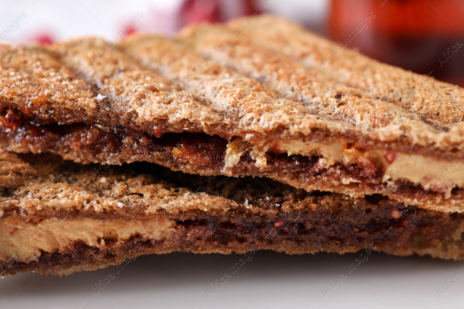 Tasty sandwiches with raspberry jam and peanut butter for breakfast, closeup Image of Tasty sandwiches with raspberry jam and peanut butter for breakfast, closeup