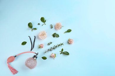 Beautiful composition with bottle of perfume and flowers on white background, flat lay. Space for text Photo of Beautiful composition with bottle of perfume and flowers on white background, flat lay. Space for text