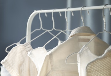 Rack with stylish women's clothes indoors. Interior design Photo of Rack with stylish women's clothes indoors. Interior design