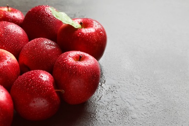 Fresh red apples with drops of water on table Photo of Fresh red apples with drops of water on table