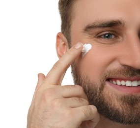 Happy young man applying facial cream on white background, closeup Photo of Happy young man applying facial cream on white background, closeup