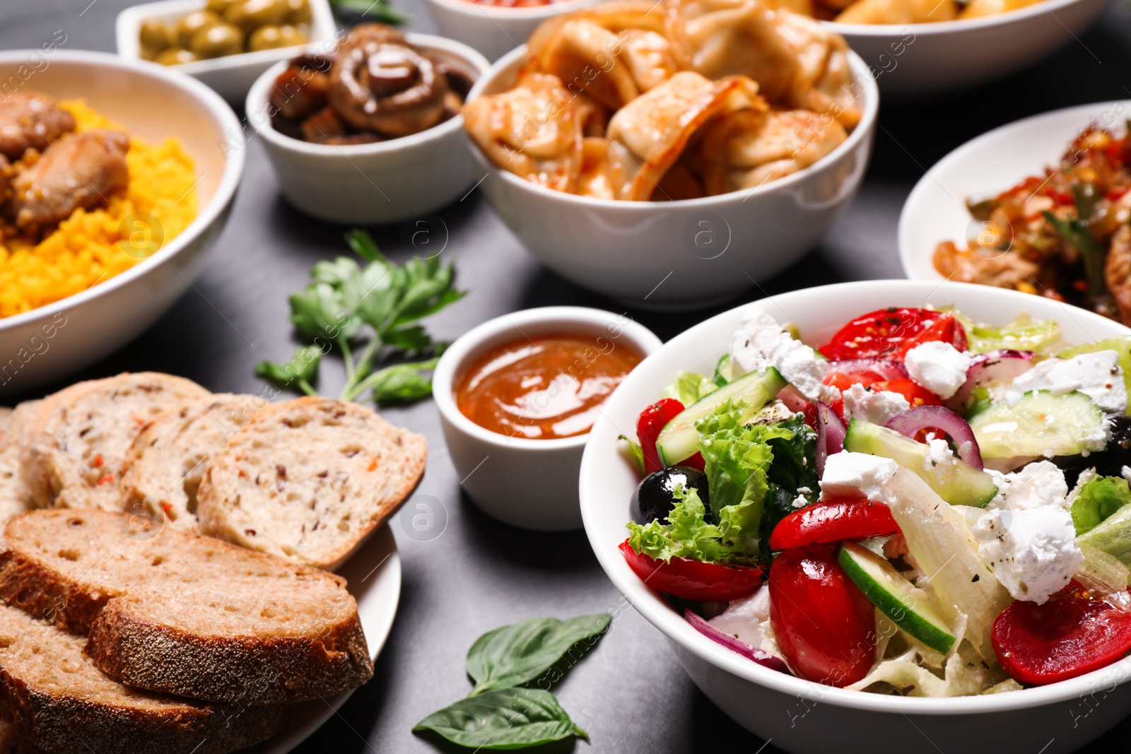 Buffet service. Many different dishes on grey table Photo of Buffet service. Many different dishes on grey table
