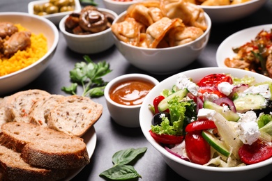 Buffet service. Many different dishes on grey table Photo of Buffet service. Many different dishes on grey table