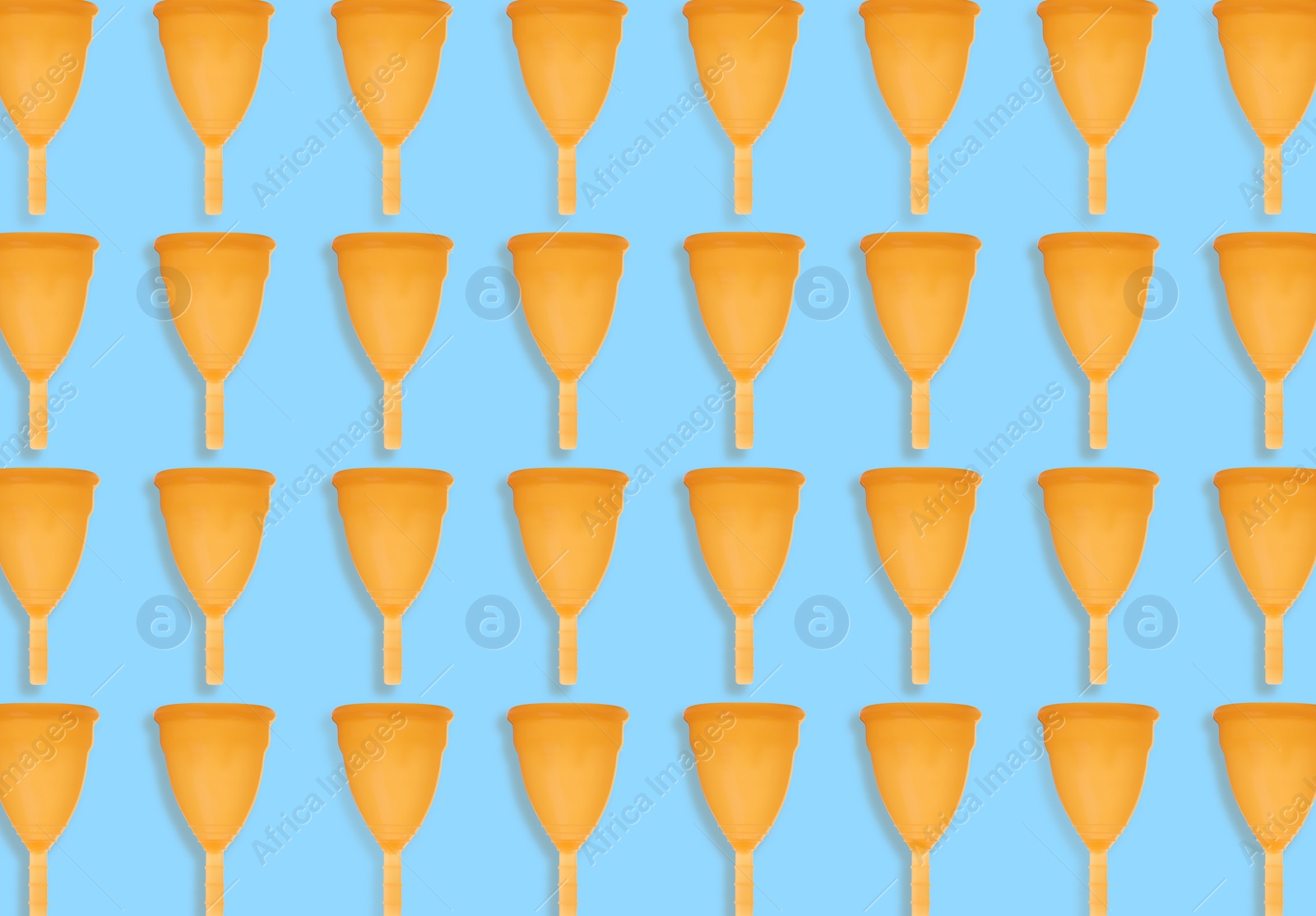 Image of Many orange menstrual cups on turquoise background, flat lay. Pattern design