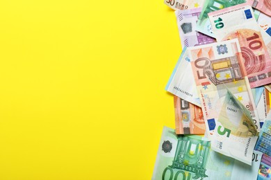 Money on yellow background, flat lay. Space for text Image of Money on yellow background, flat lay. Space for text