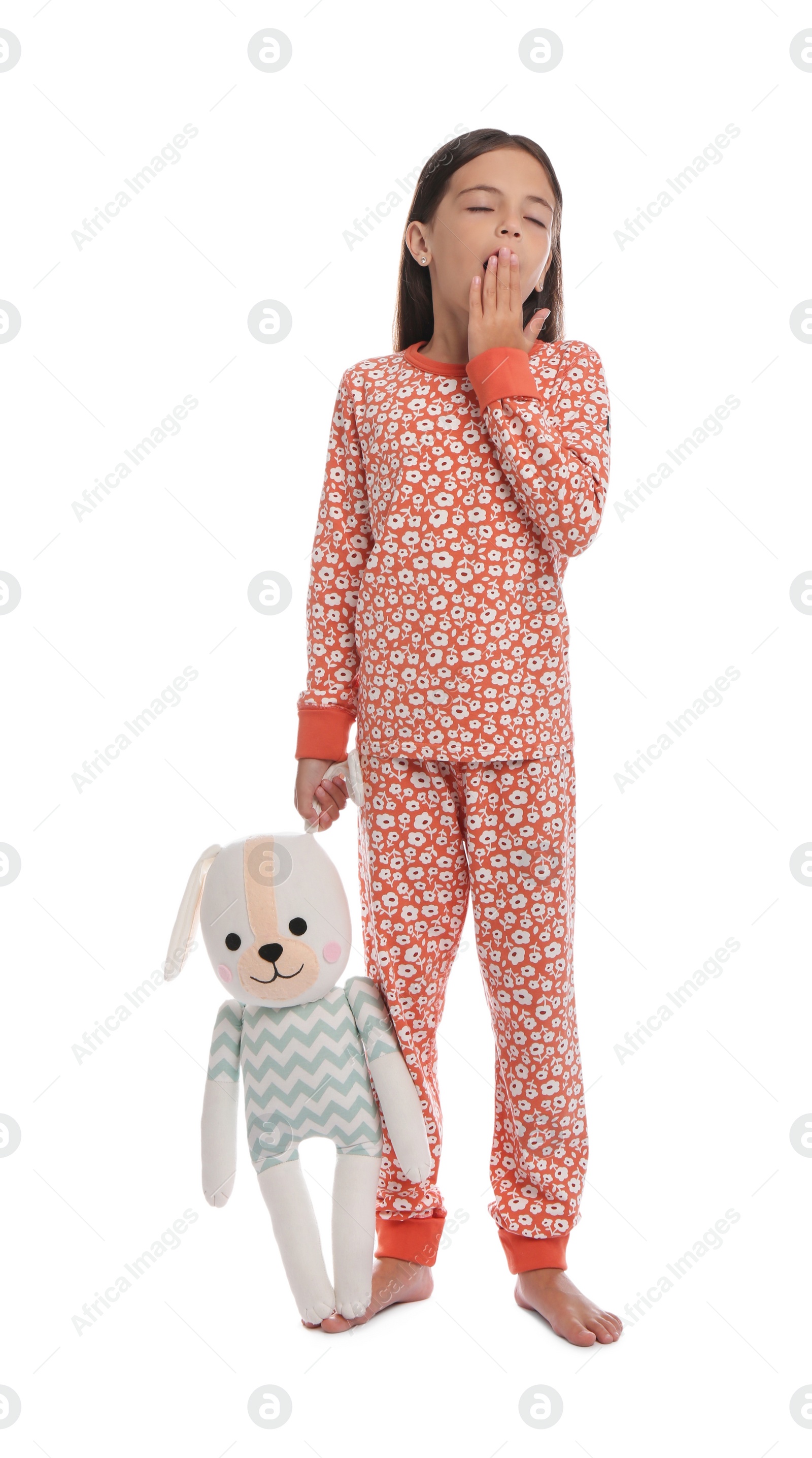 Cute girl wearing pajamas with toy on white background Photo of Cute girl wearing pajamas with toy on white background