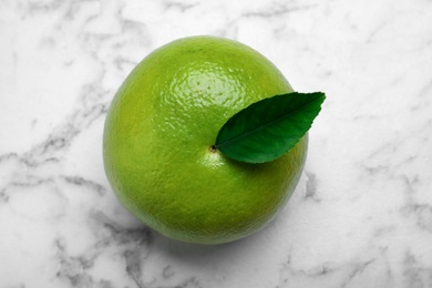 Fresh ripe sweetie fruit on white marble table, top view Photo of Fresh ripe sweetie fruit on white marble table, top view