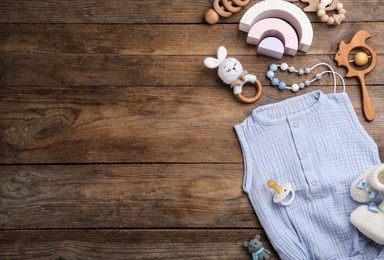 Flat lay composition with baby clothes and accessories on wooden background, space for text Photo of Flat lay composition with baby clothes and accessories on wooden background, space for text