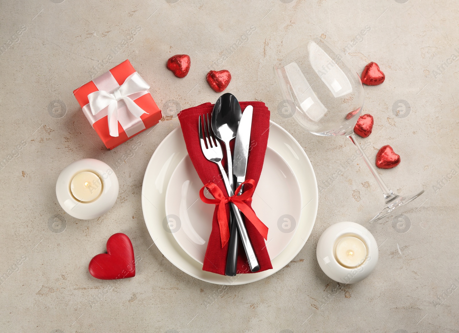 Beautiful table setting for Valentine's Day dinner on light background, flat lay Photo of Beautiful table setting for Valentine's Day dinner on light background, flat lay