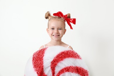 Cute little girl dressed as candy on white background. Christmas suit Image of Cute little girl dressed as candy on white background. Christmas suit