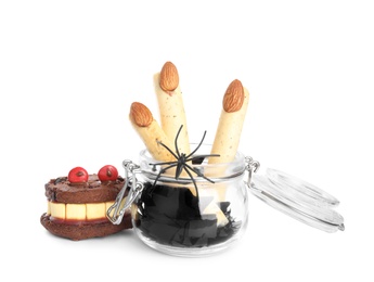 Delicious desserts decorated as monster fingers on white background. Halloween treat Photo of Delicious desserts decorated as monster fingers on white background. Halloween treat