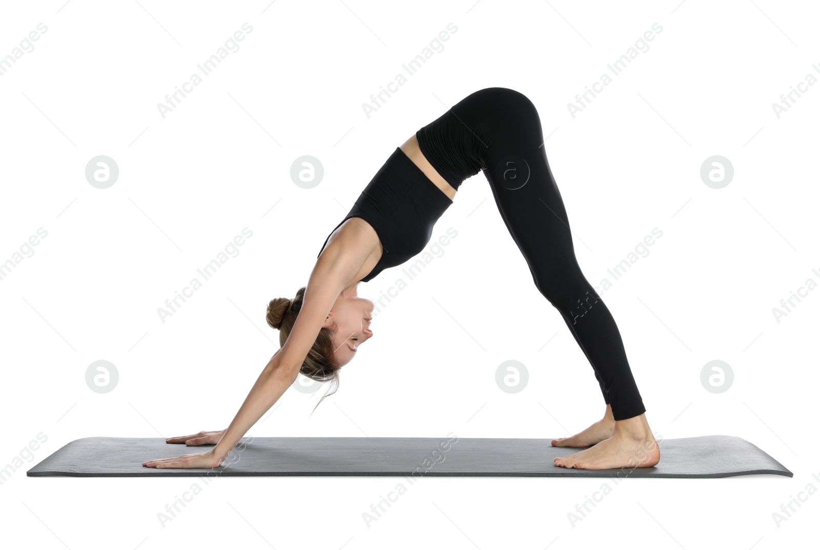 Young woman in sportswear practicing yoga on white background Photo of Young woman in sportswear practicing yoga on white background
