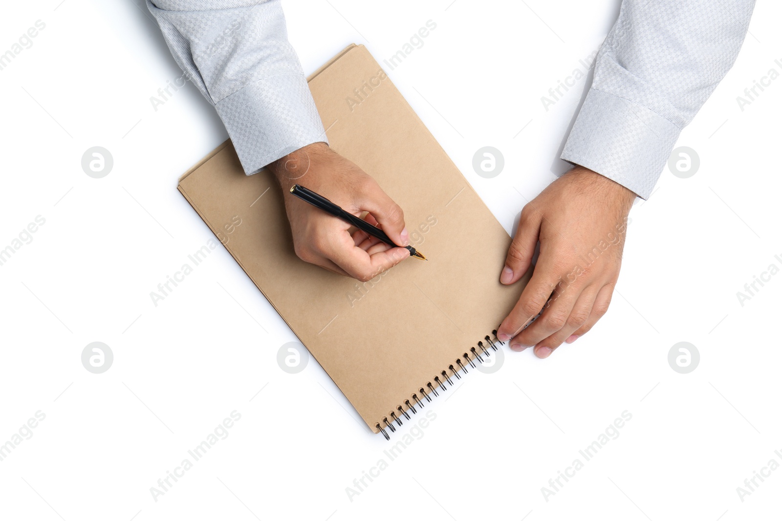 Man with pen and notepad on white background, top view. Closeup of hands Photo of Man with pen and notepad on white background, top view. Closeup of hands