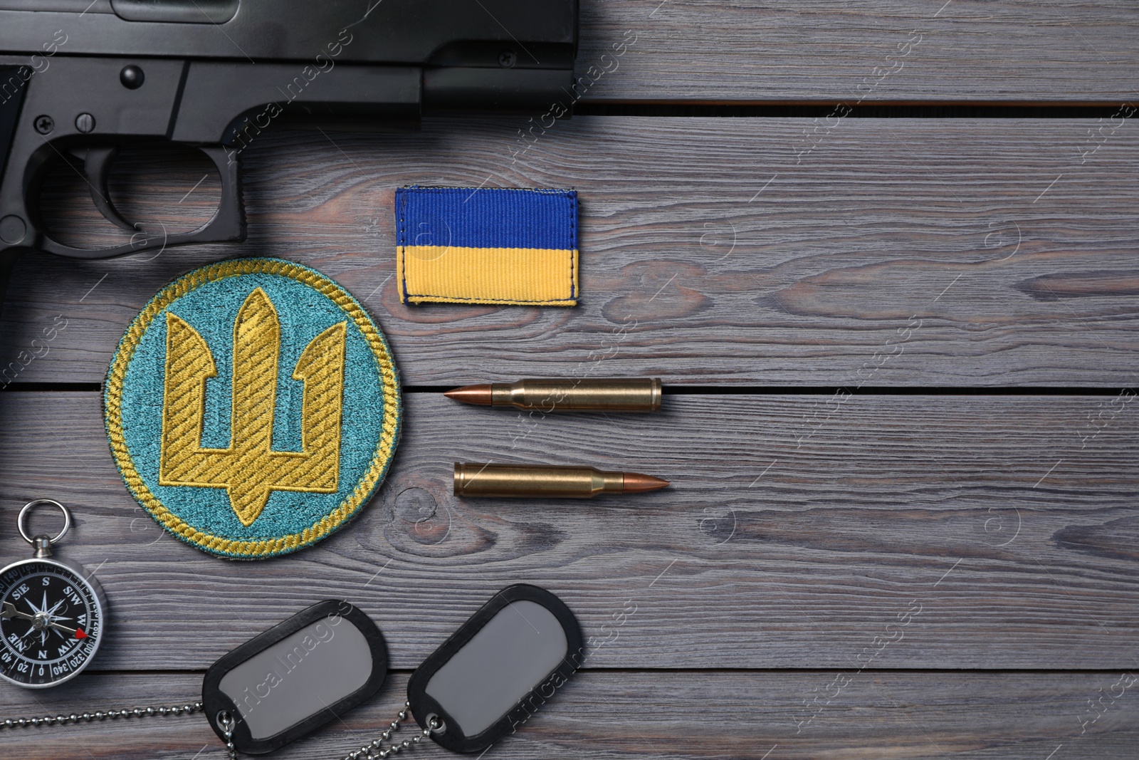 Photo of MYKOLAIV, UKRAINE - SEPTEMBER 19, 2020: Flat lay composition with Ukraine military equipment on grey wooden table