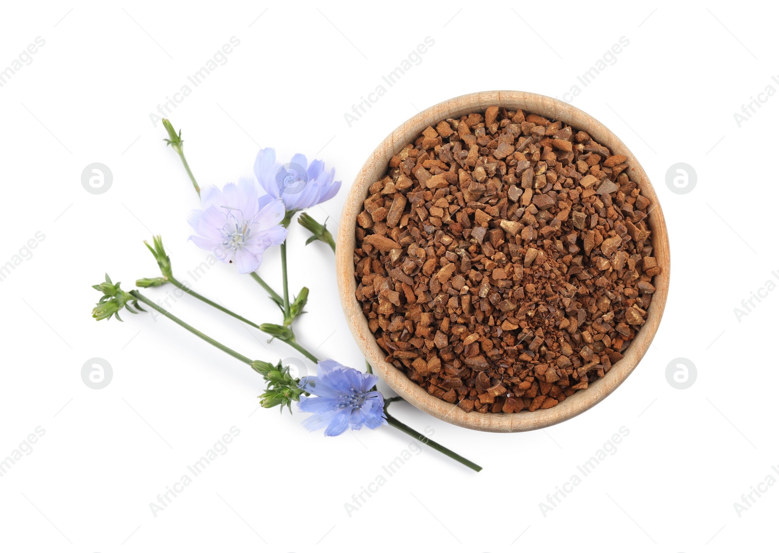Bowl of chicory granules and flowers on white background, top view Photo of Bowl of chicory granules and flowers on white background, top view