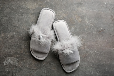 Pair of stylish soft slippers on grey background, flat lay Photo of Pair of stylish soft slippers on grey background, flat lay
