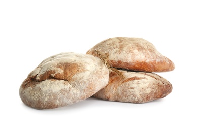 Loaves of delicious fresh bread on white background Photo of Loaves of delicious fresh bread on white background