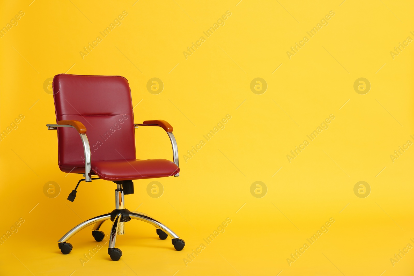 Modern office chair on yellow background. Space for text Photo of Modern office chair on yellow background. Space for text