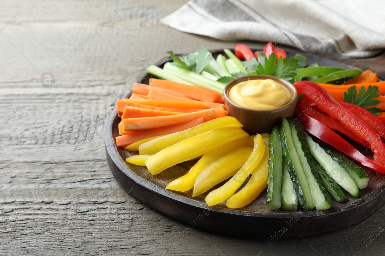 Different vegetables cut in sticks and dip sauce on wooden table, closeup Photo of Different vegetables cut in sticks and dip sauce on wooden table, closeup