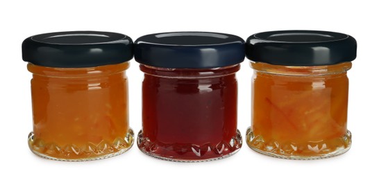 Jars with different jams on white background Photo of Jars with different jams on white background