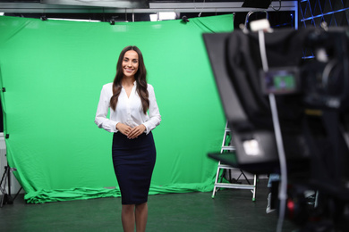 Presenter and video camera operator working in studio. News broadcasting Photo of Presenter and video camera operator working in studio. News broadcasting