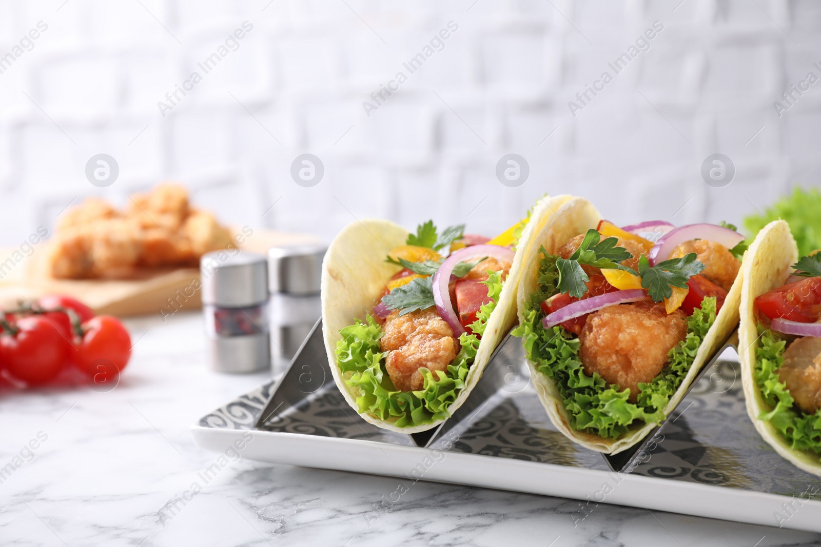 Yummy fish tacos served on white marble table Photo of Yummy fish tacos served on white marble table