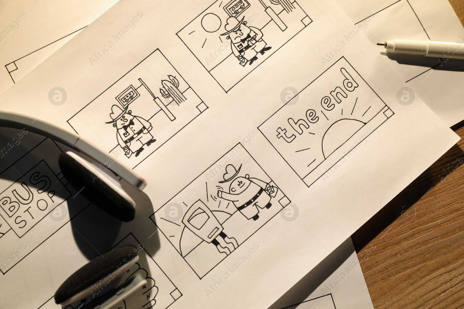 Photo of Storyboards with cartoon sketches at workplace, flat lay. Pre-production process