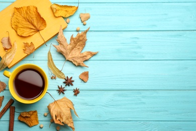 Flat lay composition with cup of hot drink and autumn leaves on light blue wooden table, space for text. Cozy atmosphere Photo of Flat lay composition with cup of hot drink and autumn leaves on light blue wooden table, space for text. Cozy atmosphere