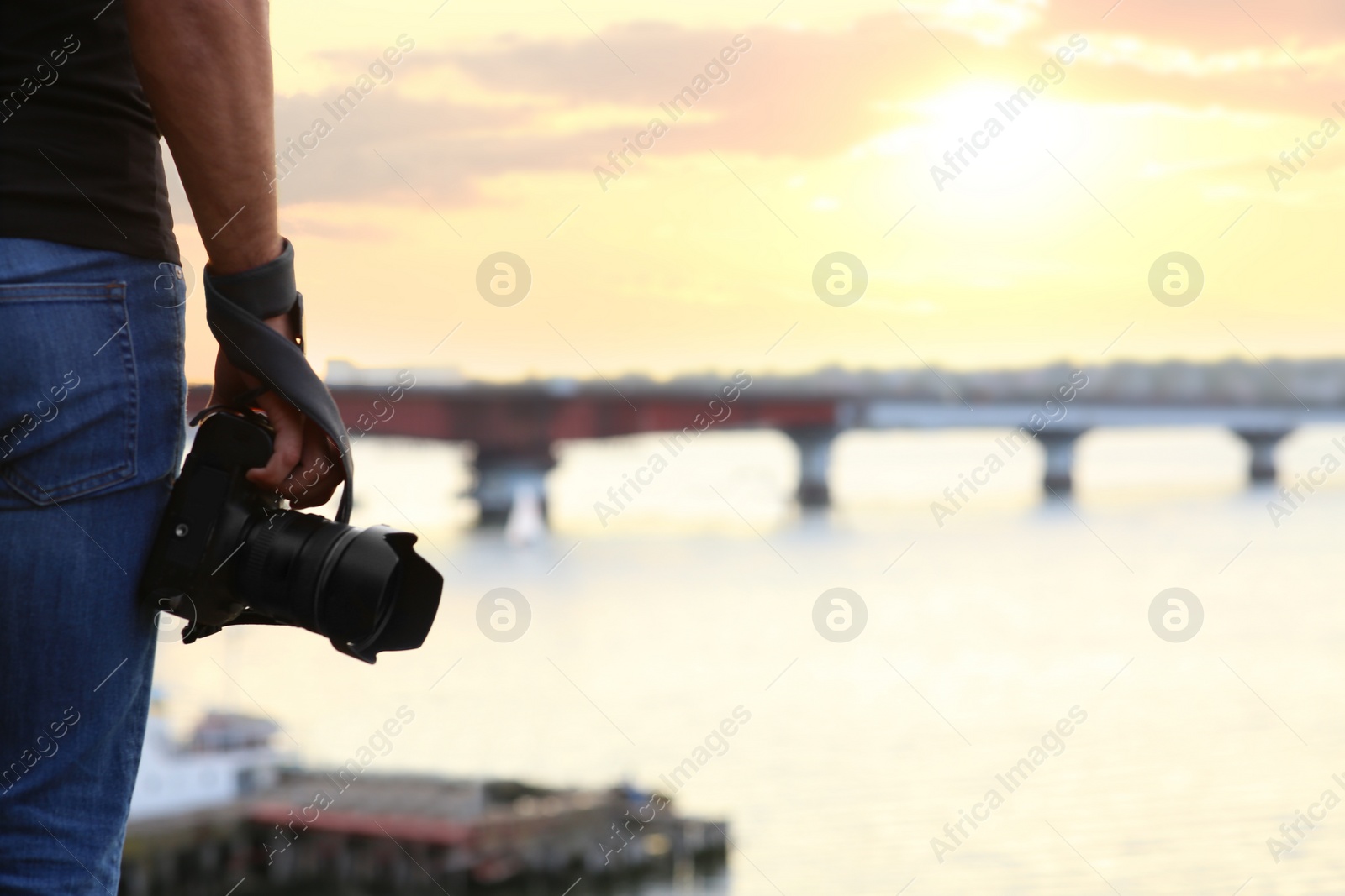 Photographer with professional camera near river, closeup Photo of Photographer with professional camera near river, closeup