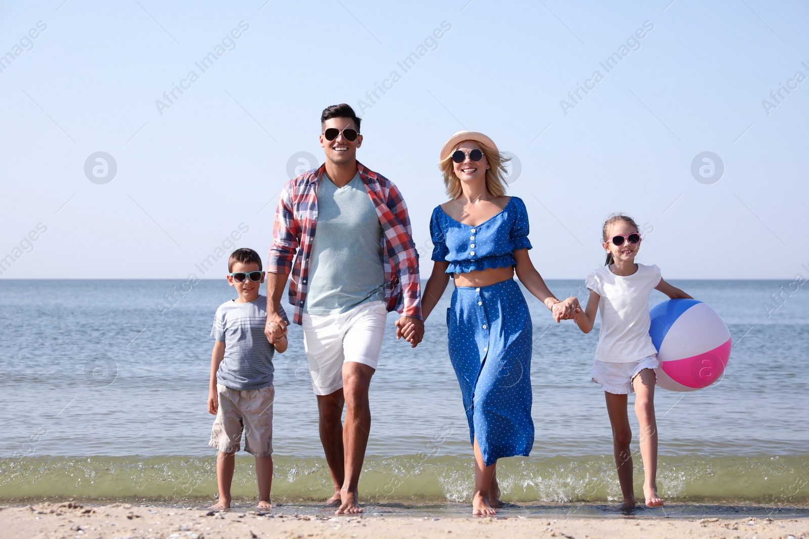 Happy family at beach on sunny summer day Photo of Happy family at beach on sunny summer day