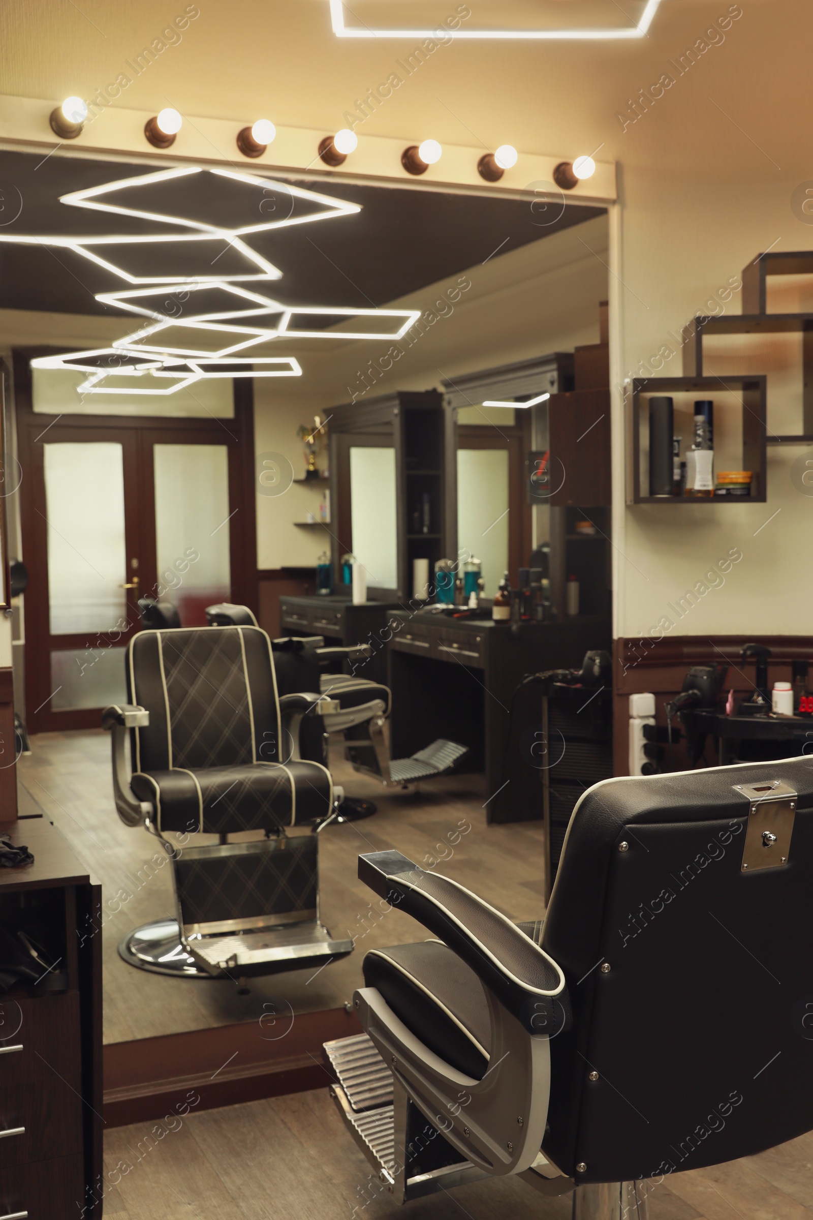 Stylish hairdresser's workplace with professional armchair in barbershop Photo of Stylish hairdresser's workplace with professional armchair in barbershop