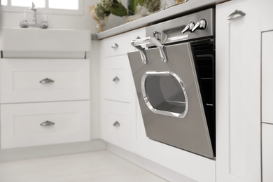 Photo of New modern oven in stylish kitchen. Cooking appliance