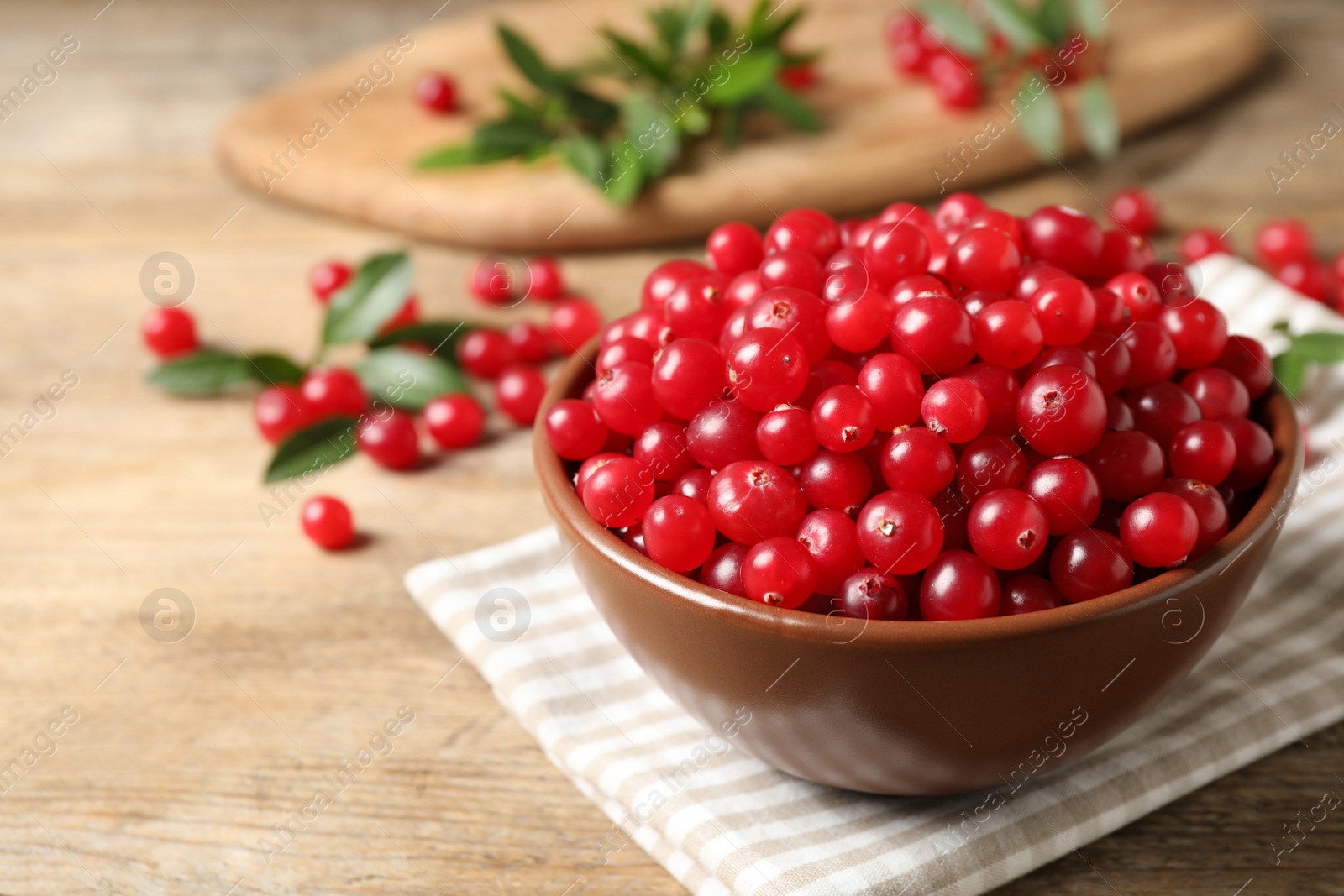 Tasty ripe cranberries on wooden table, closeup Photo of Tasty ripe cranberries on wooden table, closeup