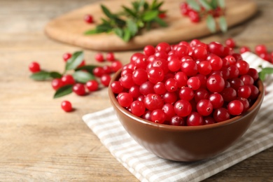 Tasty ripe cranberries on wooden table, closeup Photo of Tasty ripe cranberries on wooden table, closeup