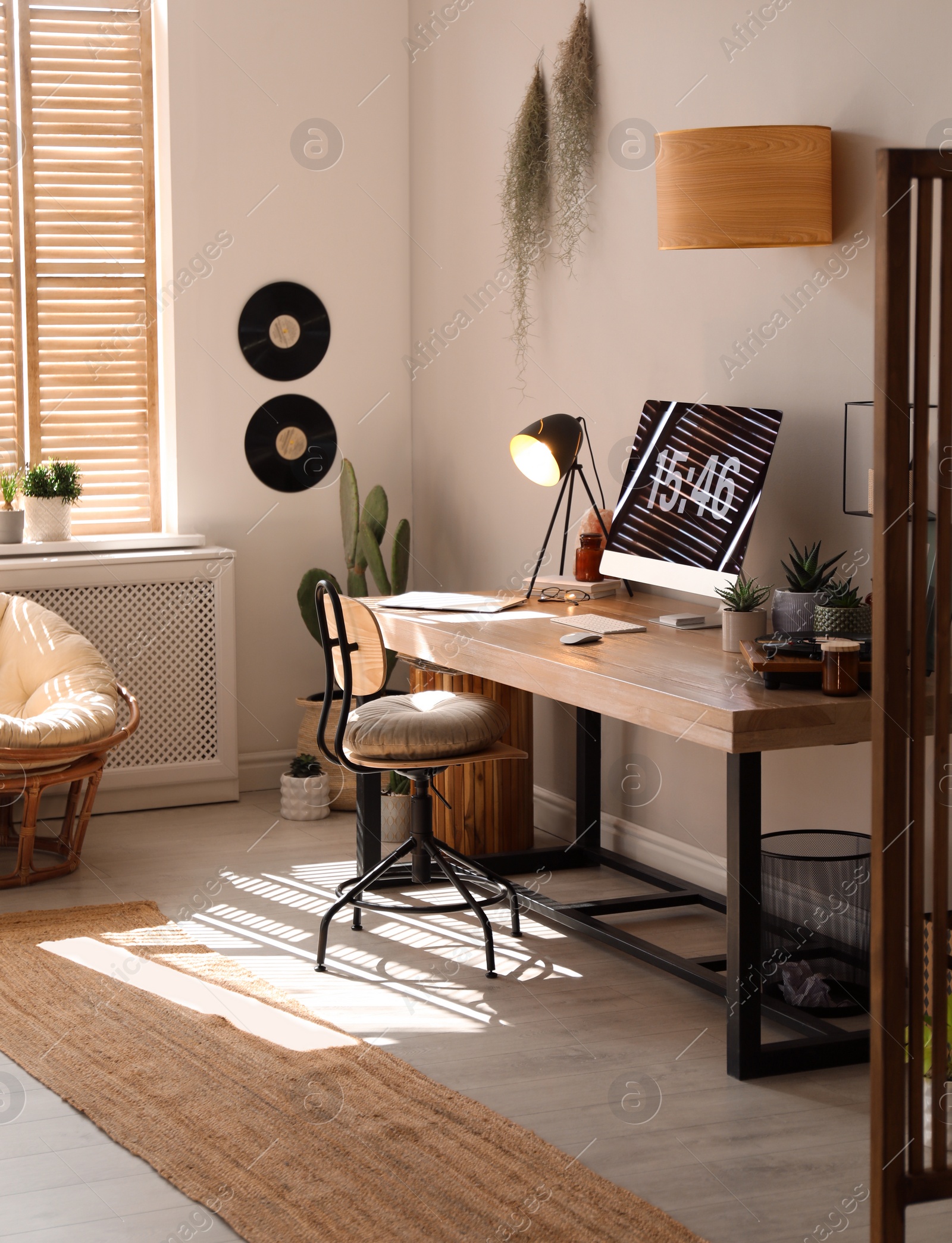 Room interior with comfortable workplace. Modern computer on wooden desk Photo of Room interior with comfortable workplace. Modern computer on wooden desk