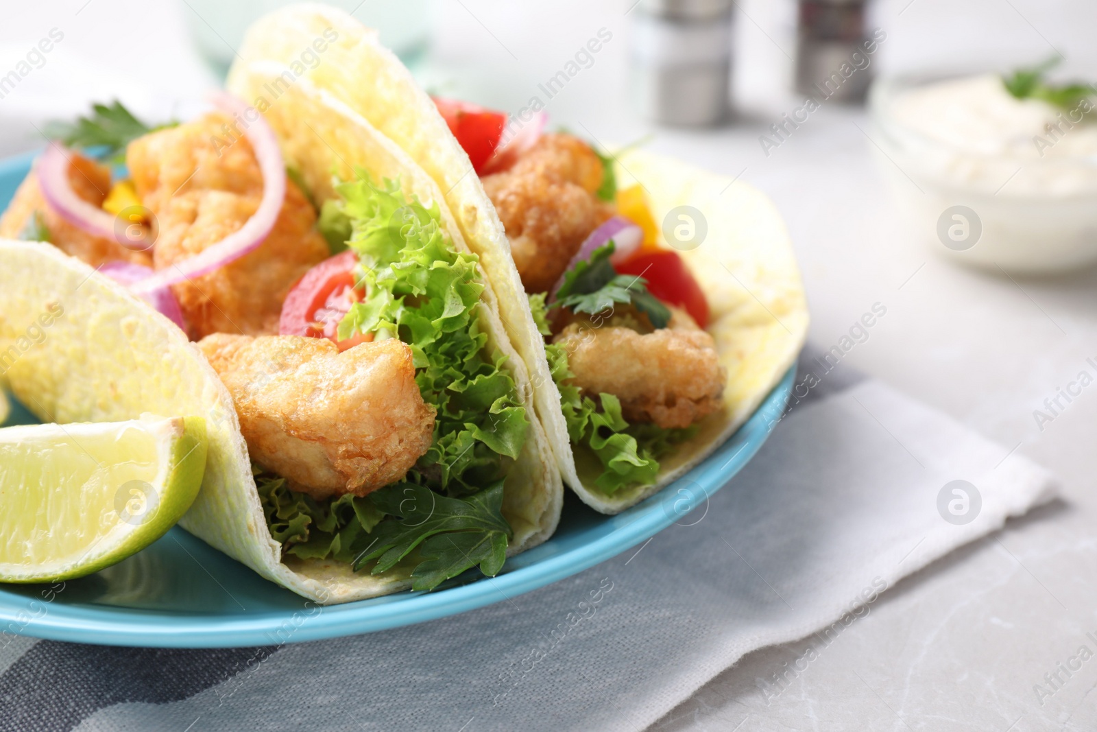 Yummy fish tacos served on table, closeup Photo of Yummy fish tacos served on table, closeup