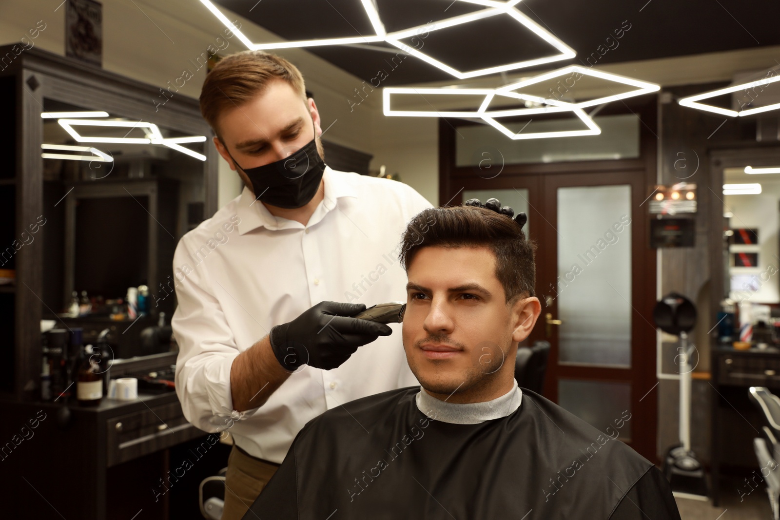 Professional hairdresser making stylish haircut in salon Photo of Professional hairdresser making stylish haircut in salon