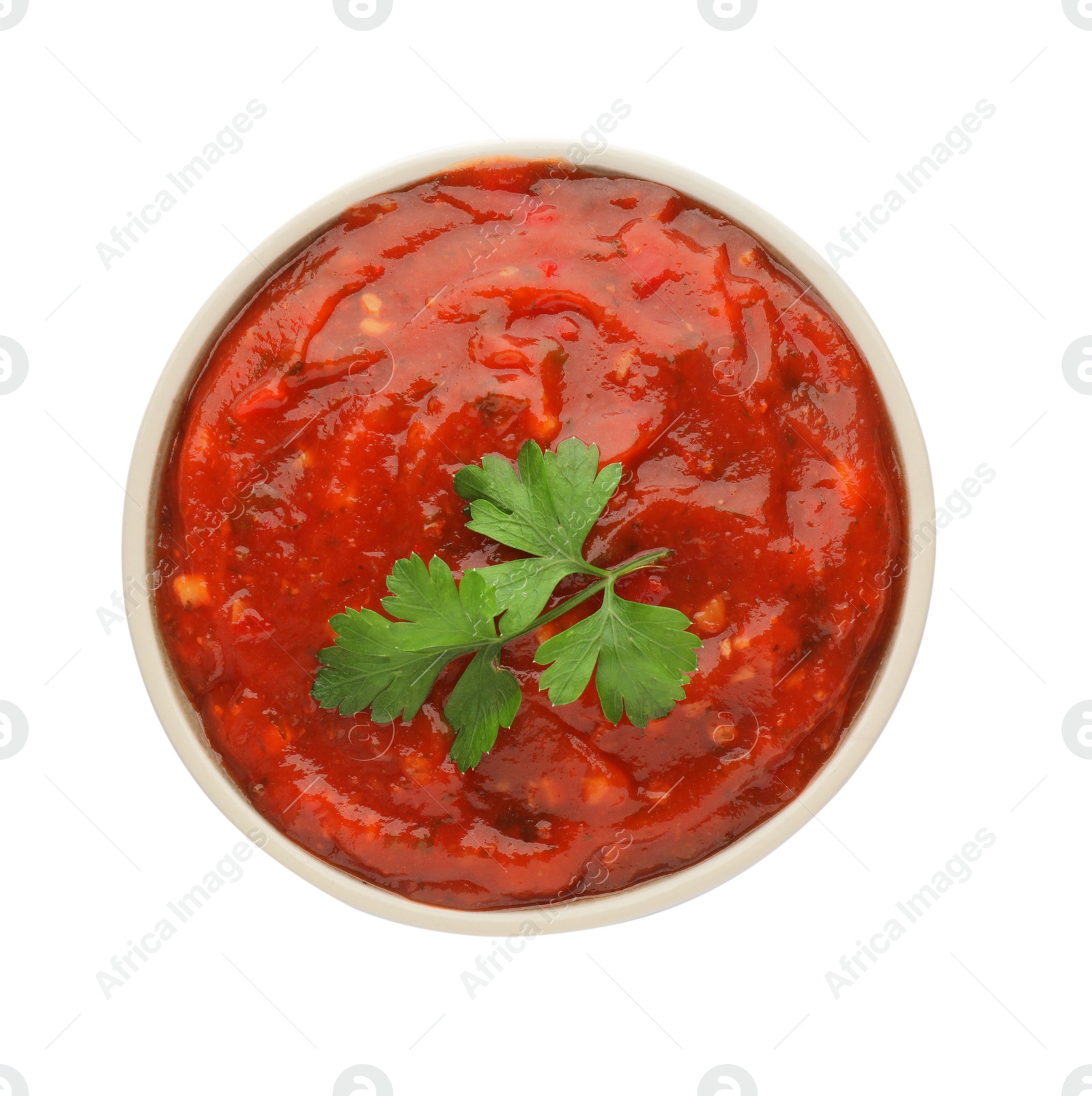 Delicious adjika sauce and parsley in bowl isolated on white, top view Photo of Delicious adjika sauce and parsley in bowl isolated on white, top view