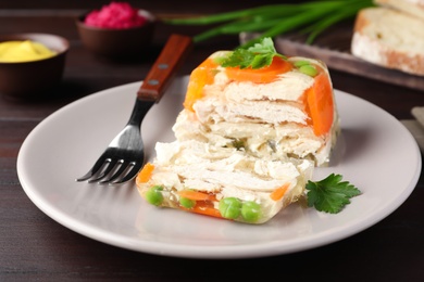 Delicious chicken aspic served on wooden table, closeup Photo of Delicious chicken aspic served on wooden table, closeup