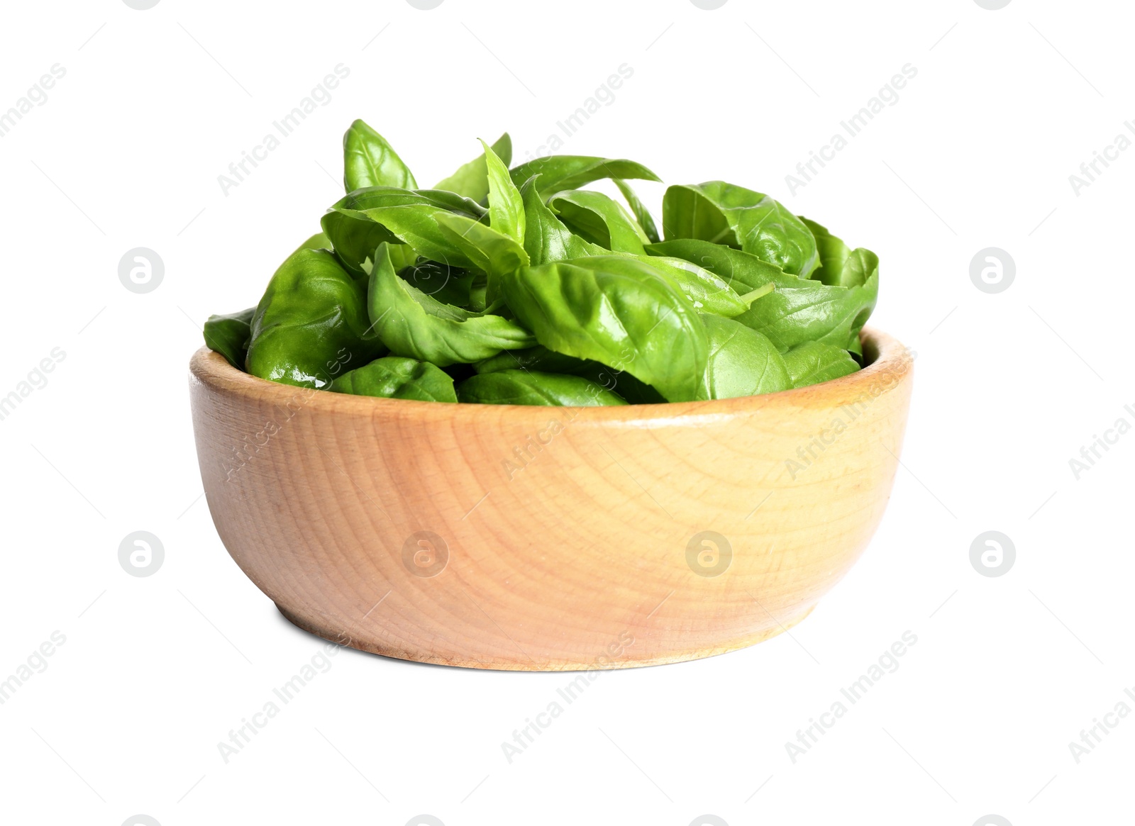 Photo of Fresh green basil leaves in wooden bowl isolated on white